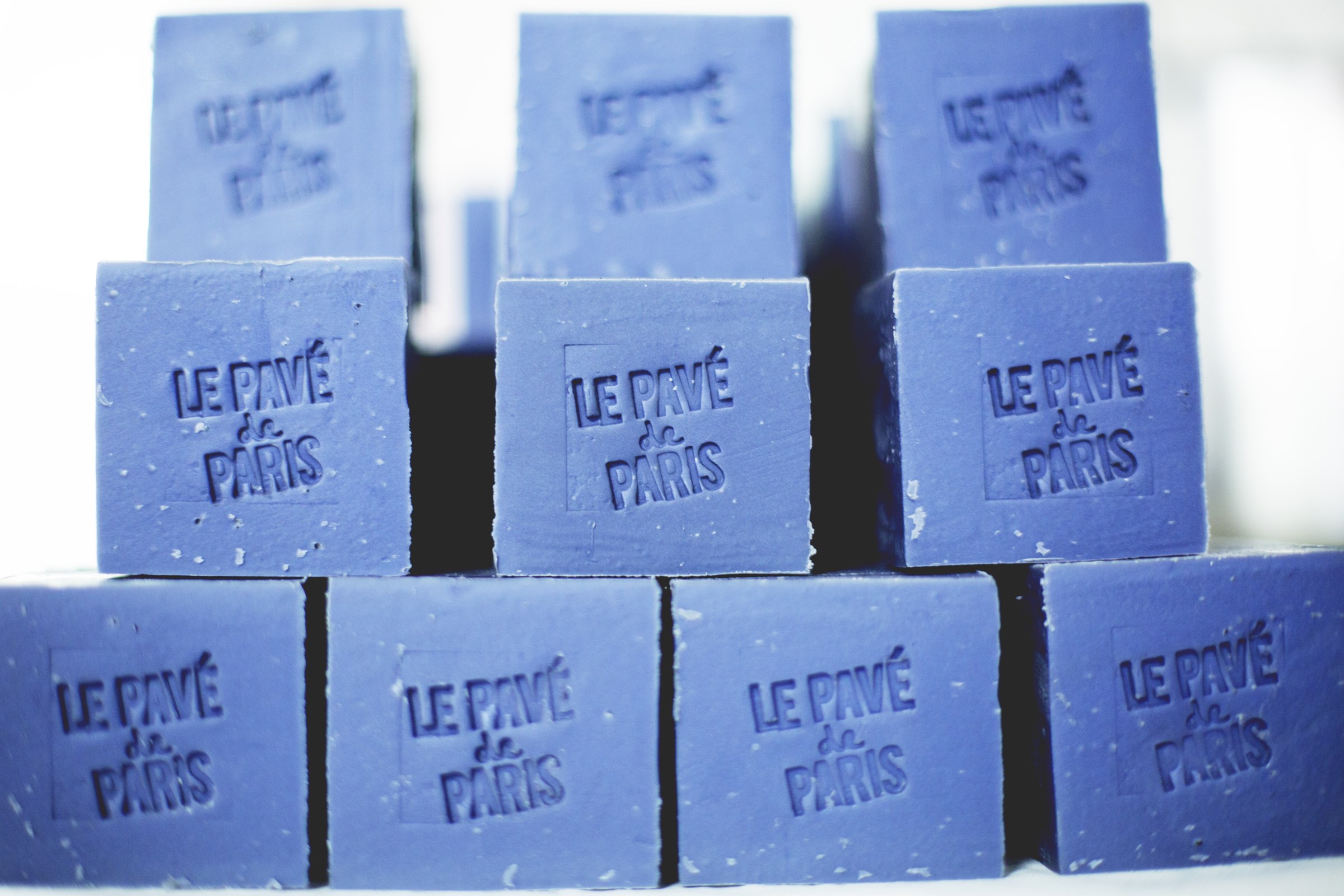 Empilement de pavés de savon Le Bleu estampillés Le Pavé de Paris.